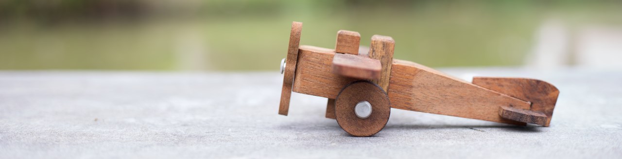 A wooden toy plane waits for its pilot