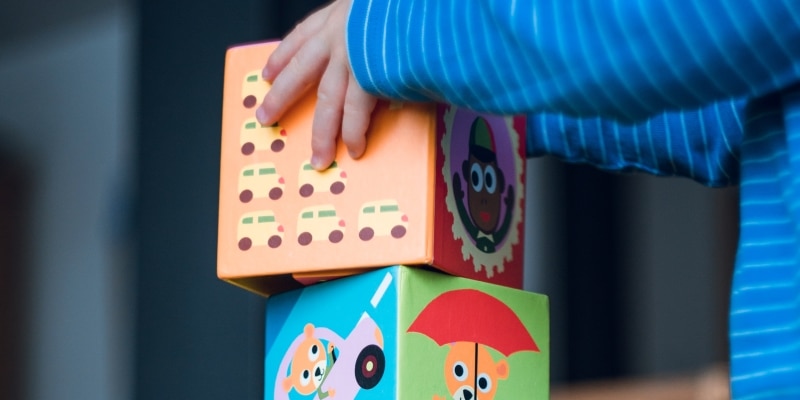 Close up of child's hands while playing with building blocks