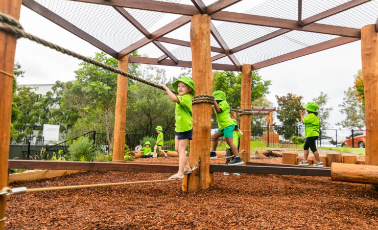 Children playing and being active in the garden playground of Grace Village Early Learning Centre, Blacktown